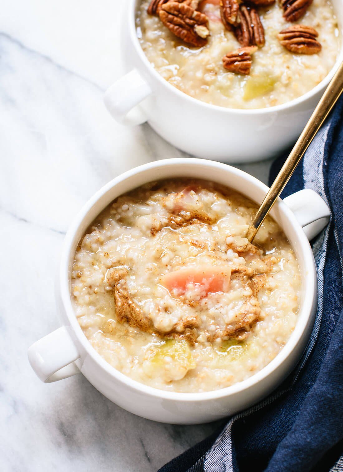 Simple apple oatmeal recipe made with steel-cut oats! The oats and apples cook together in the same pot. It's a healthy and delicious fall breakfast. cookieandkate.com