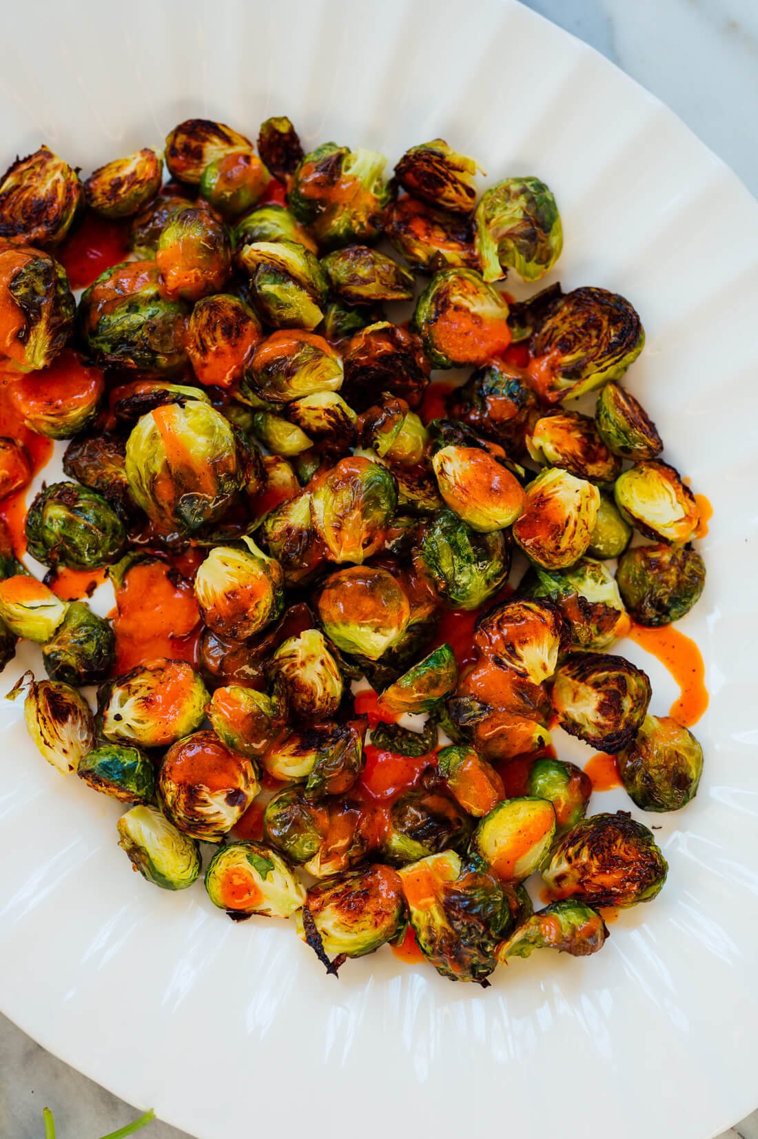 Buffalo sauce drizzled on Brussels sprouts