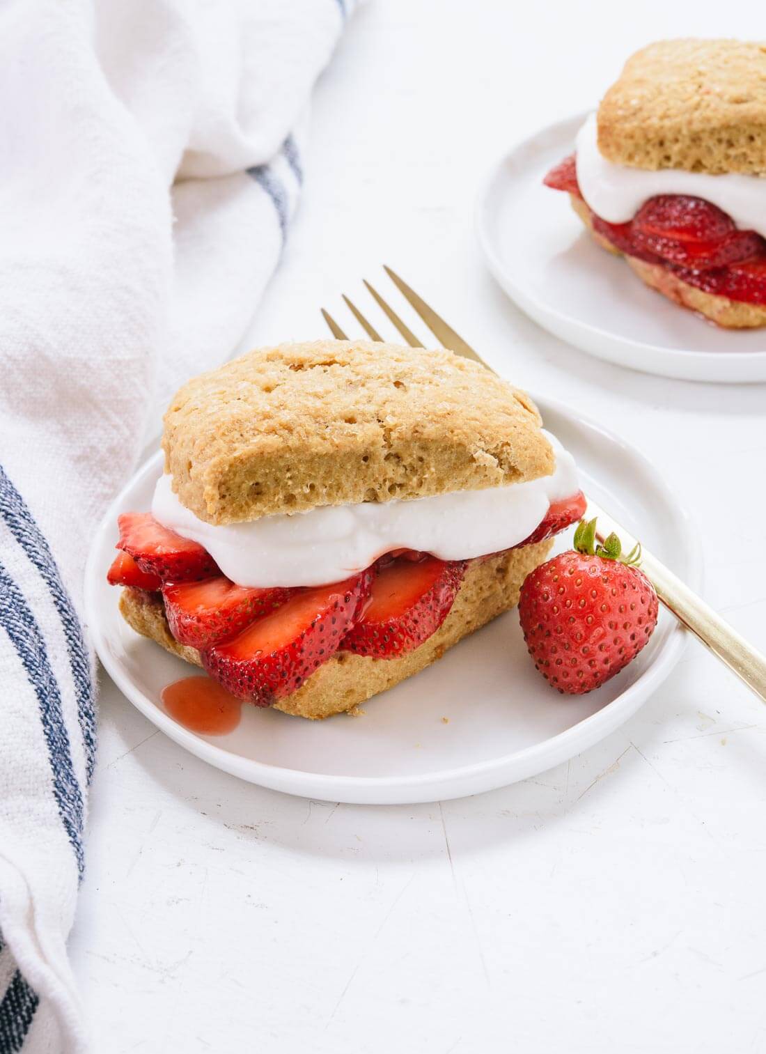 Classic strawberry shortcake made healthier with honey, whole grains and coconut whipped cream. Easily vegan, too. cookieandkate.com