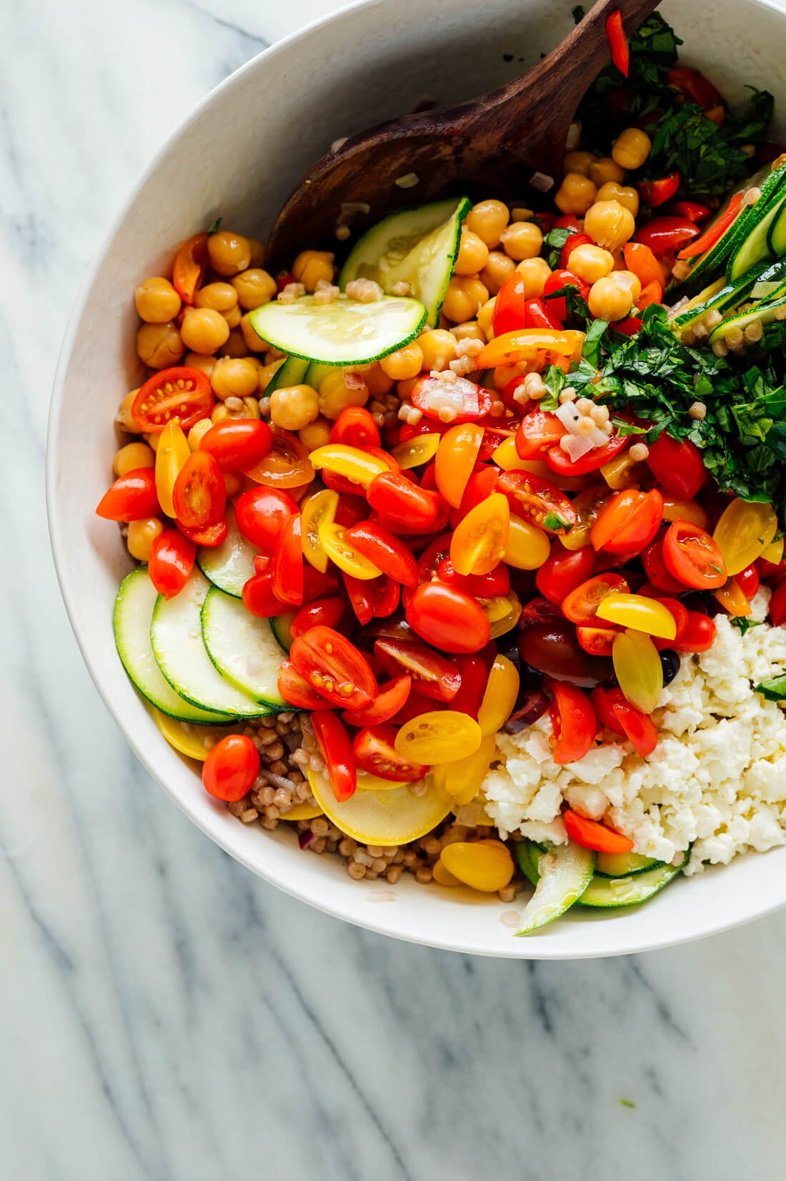 couscous salad with raw zucchini, cherry tomatoes and basil