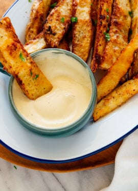 crispy potato wedge dipped into aioli