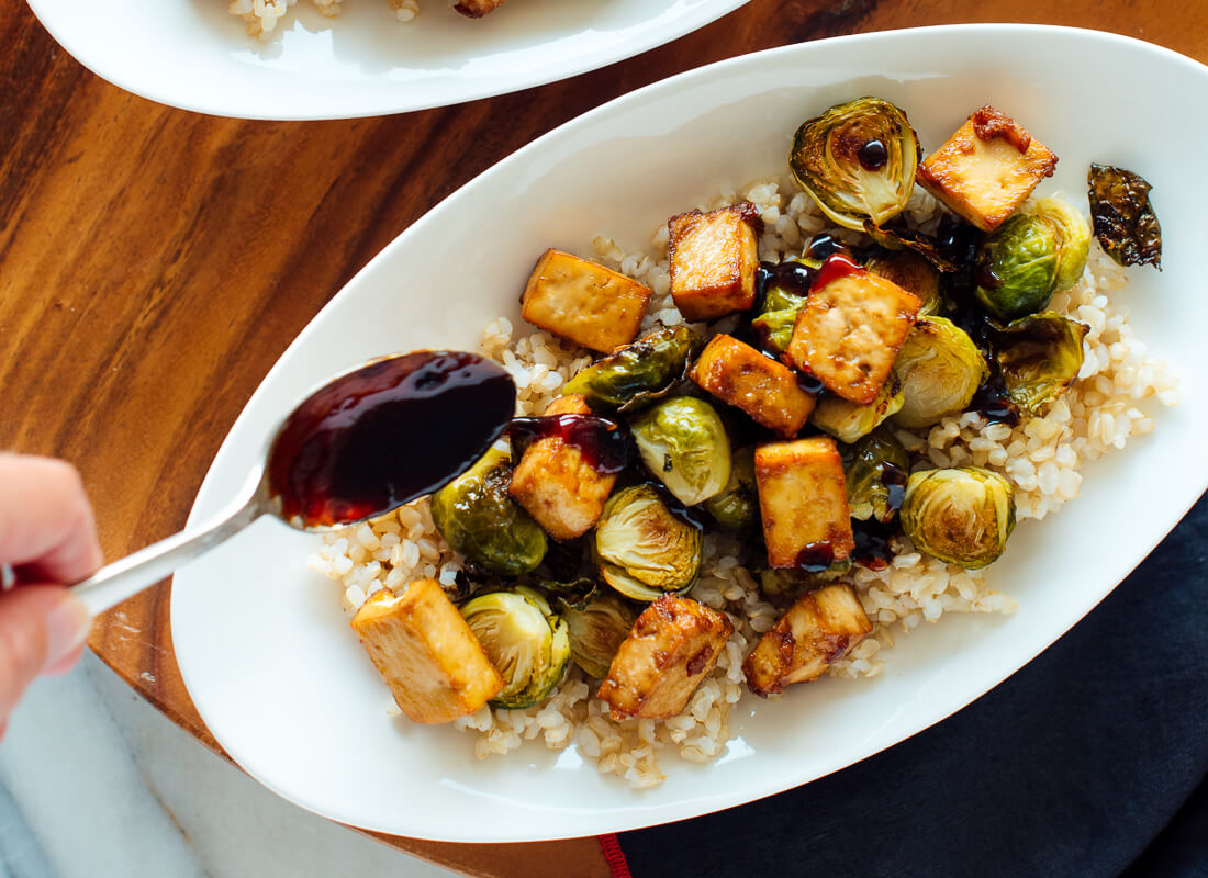 drizzling glaze over Brussels and tofu