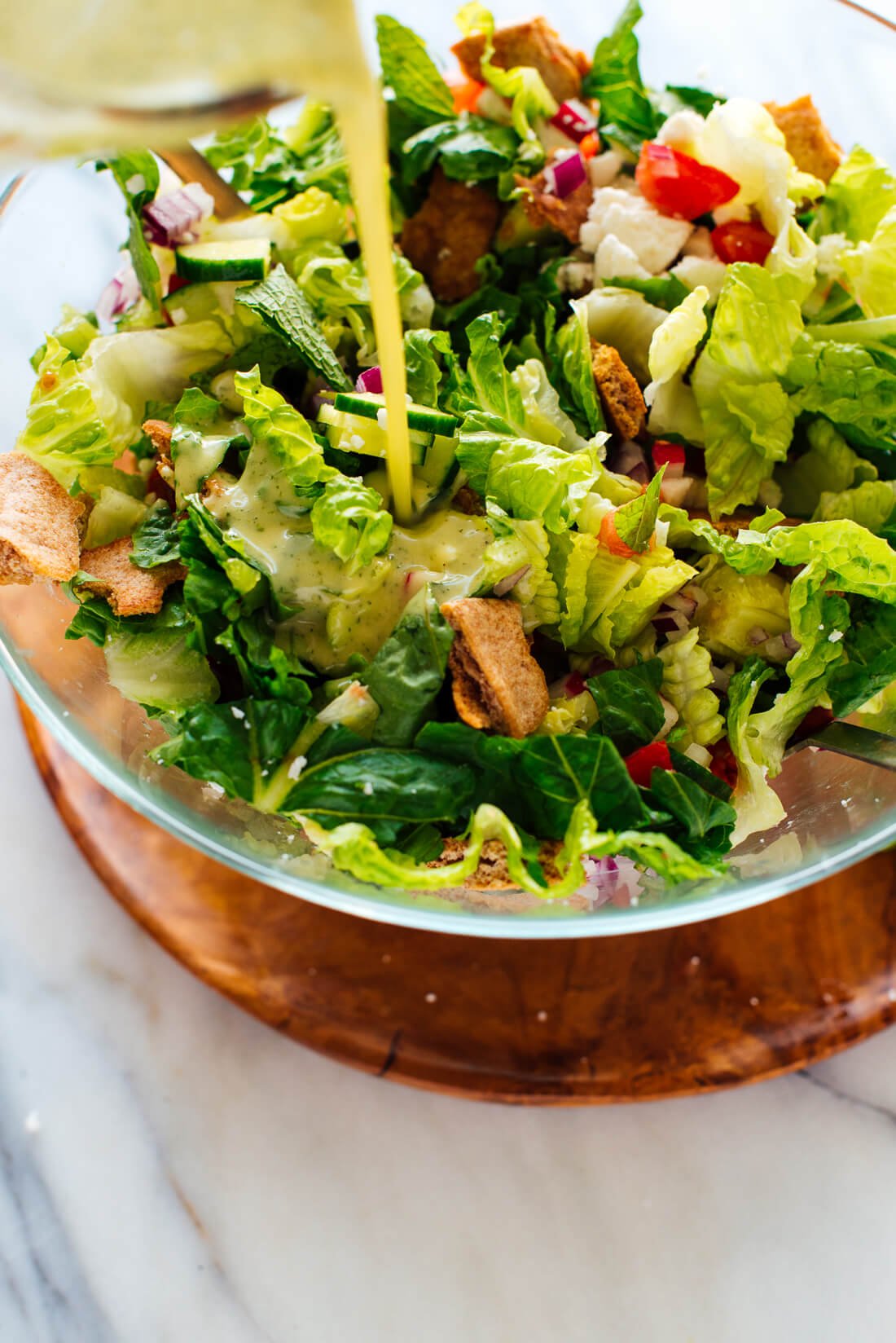 mint dressing poured over fattoush salad