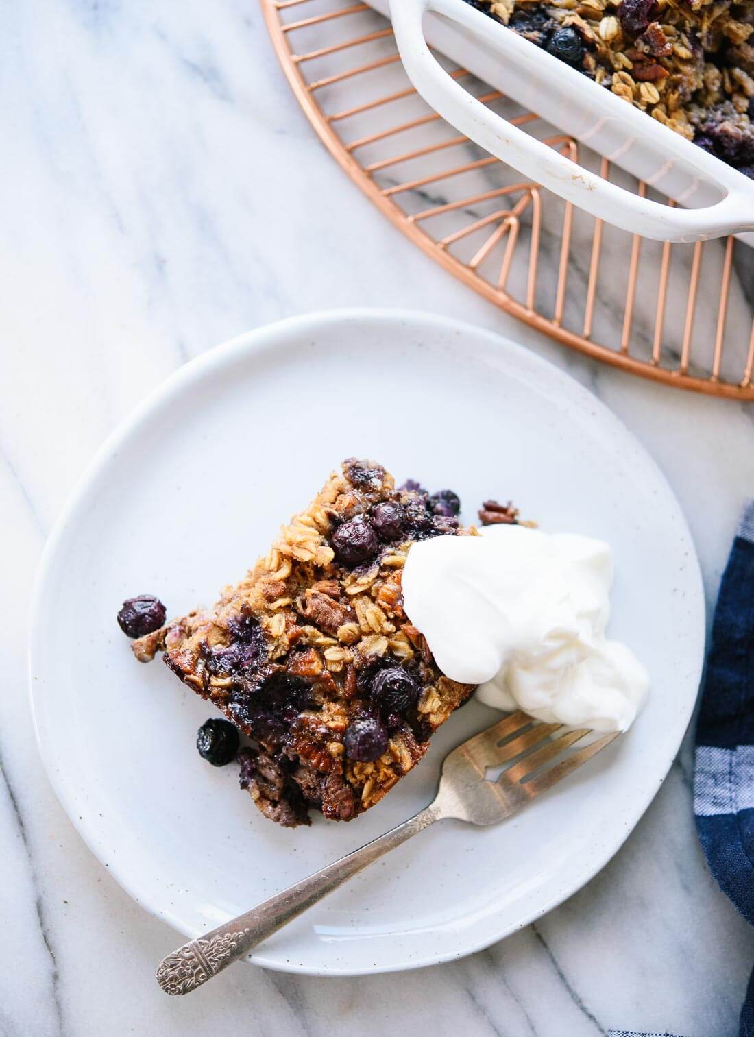 Healthy baked oatmeal made with oats, blueberries and warming spices! Naturally sweetened with maple syrup, too. cookieandkate.com