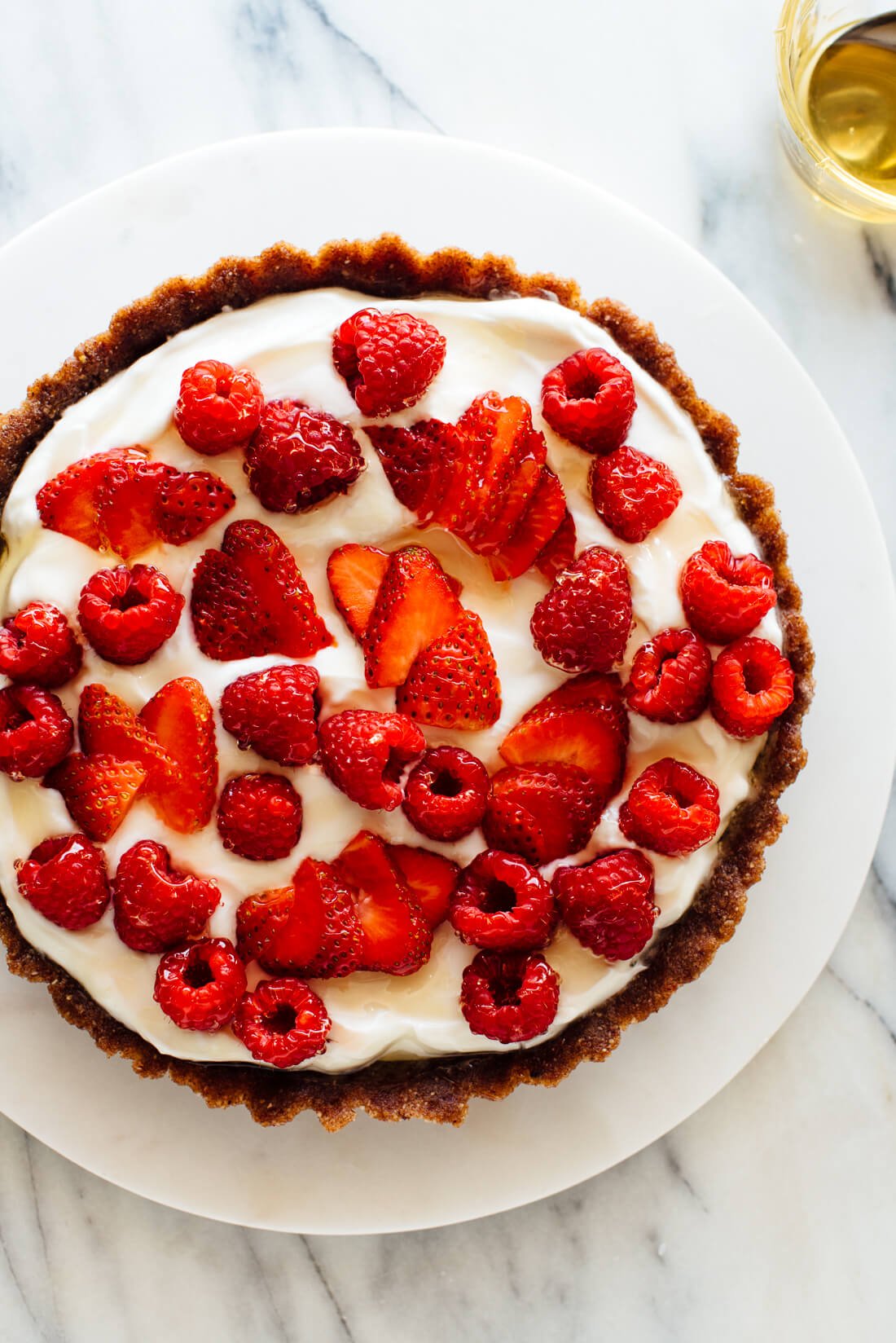 healthy greek yogurt tart topped with raspberries and strawberries