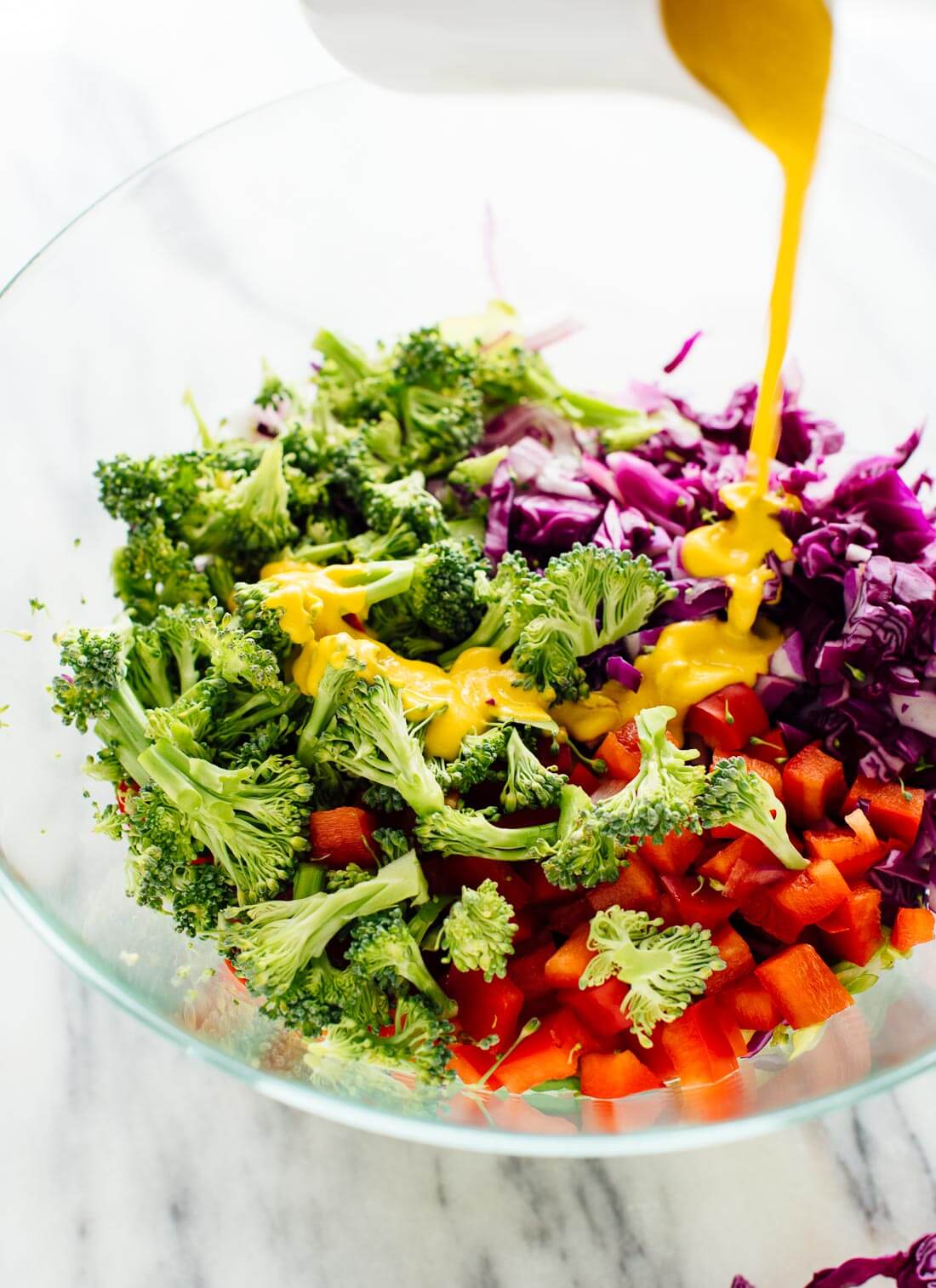 Healthy green salad recipe featuring chopped broccoli, bell pepper and cabbage in a zingy carrot-ginger dressing!