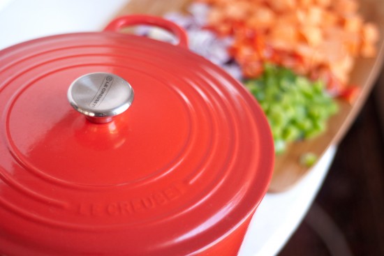 Red Le Creuset French oven and chili ingredients