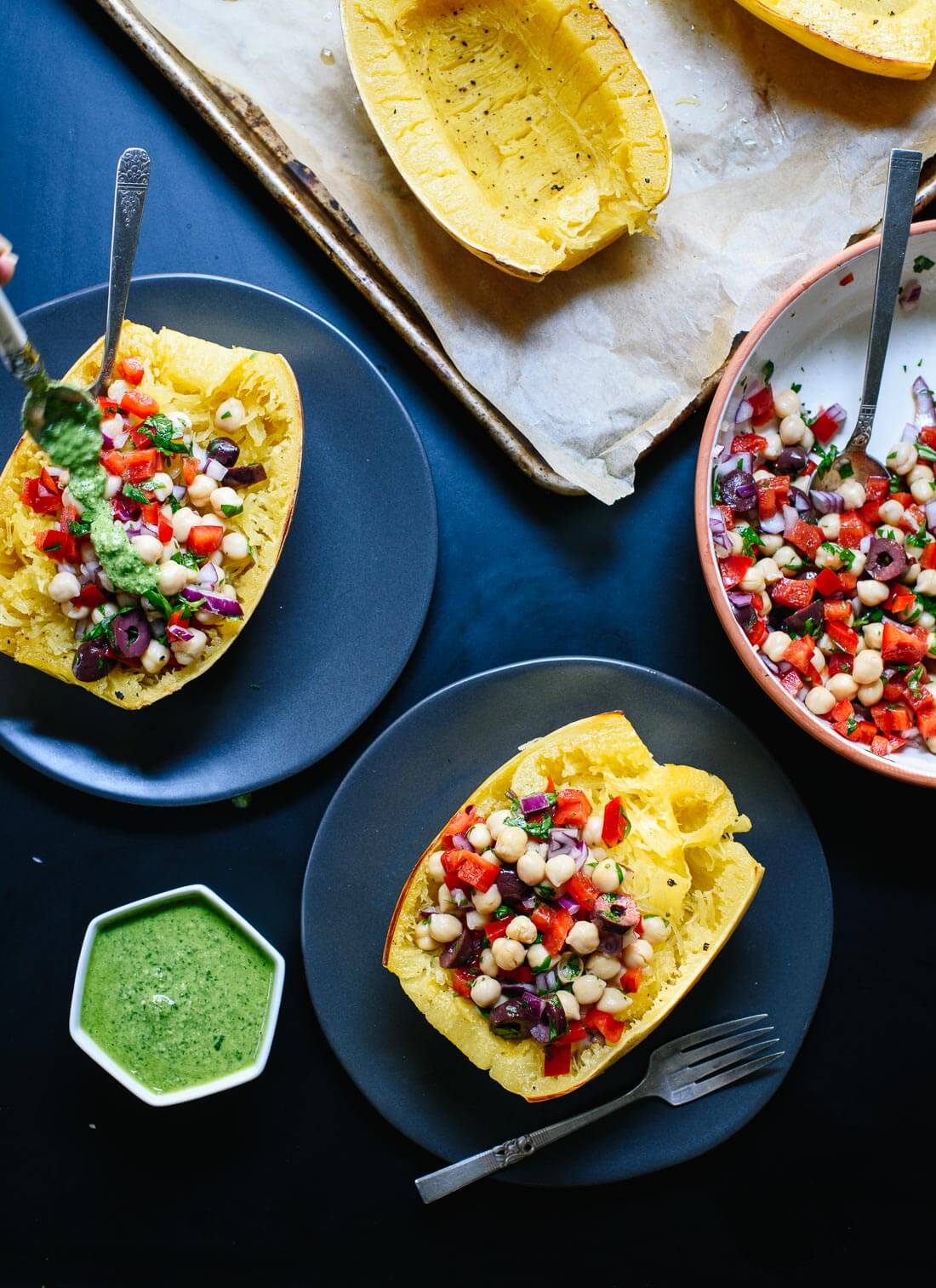 Mediterranean spaghetti squash bowls topped with pesto! So fresh and delicious. cookieandkate.com