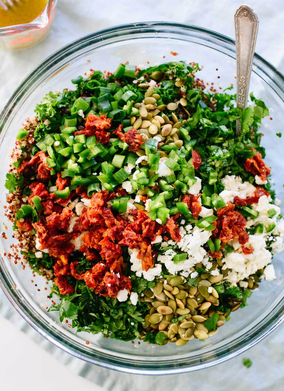 Mexican quinoa and kale salad with pepitas, black beans, sun-dried tomatoes and a cumin-lime dressing. cookieandkate.com