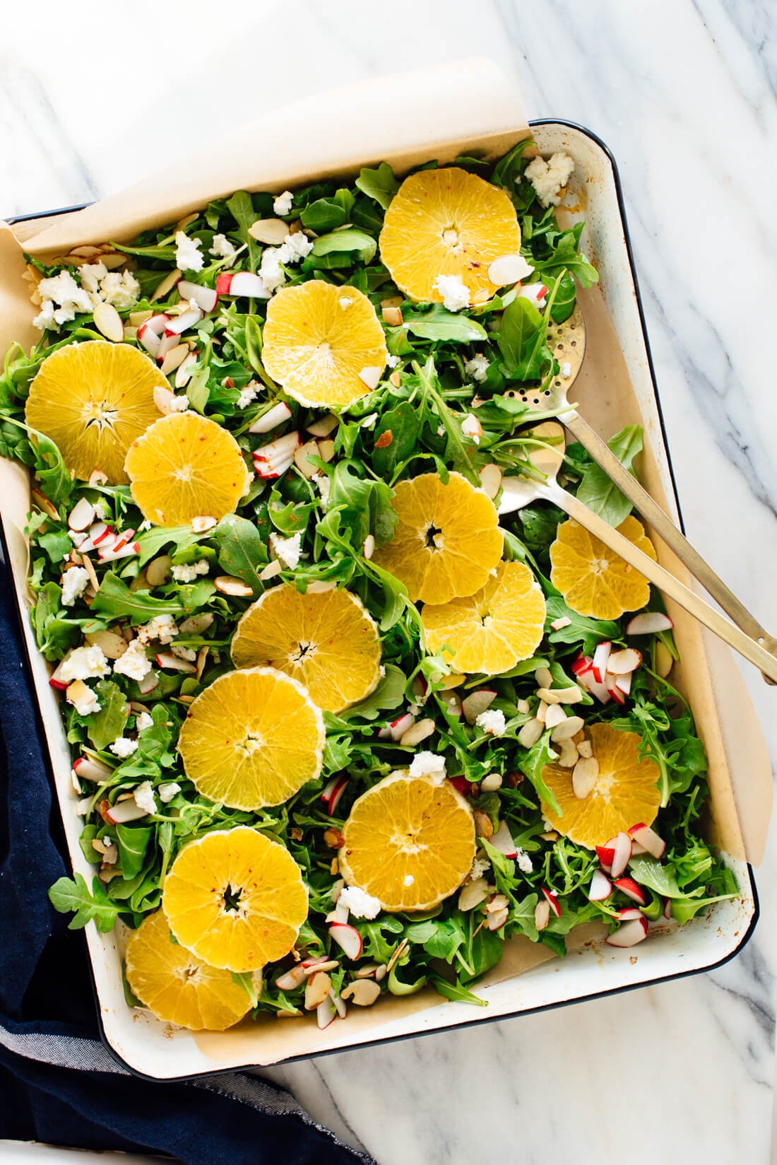 orange arugula salad with goat cheese, almonds and radishes