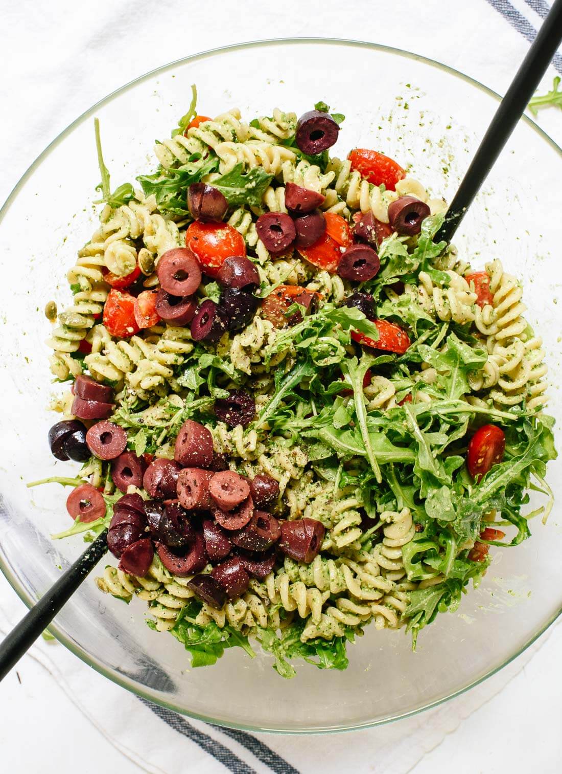 This pesto pasta salad recipe is bursting with bold, fresh flavors! It's light, healthy, and sure to please everyone. Vegan and easily gluten free. cookieandkate.com