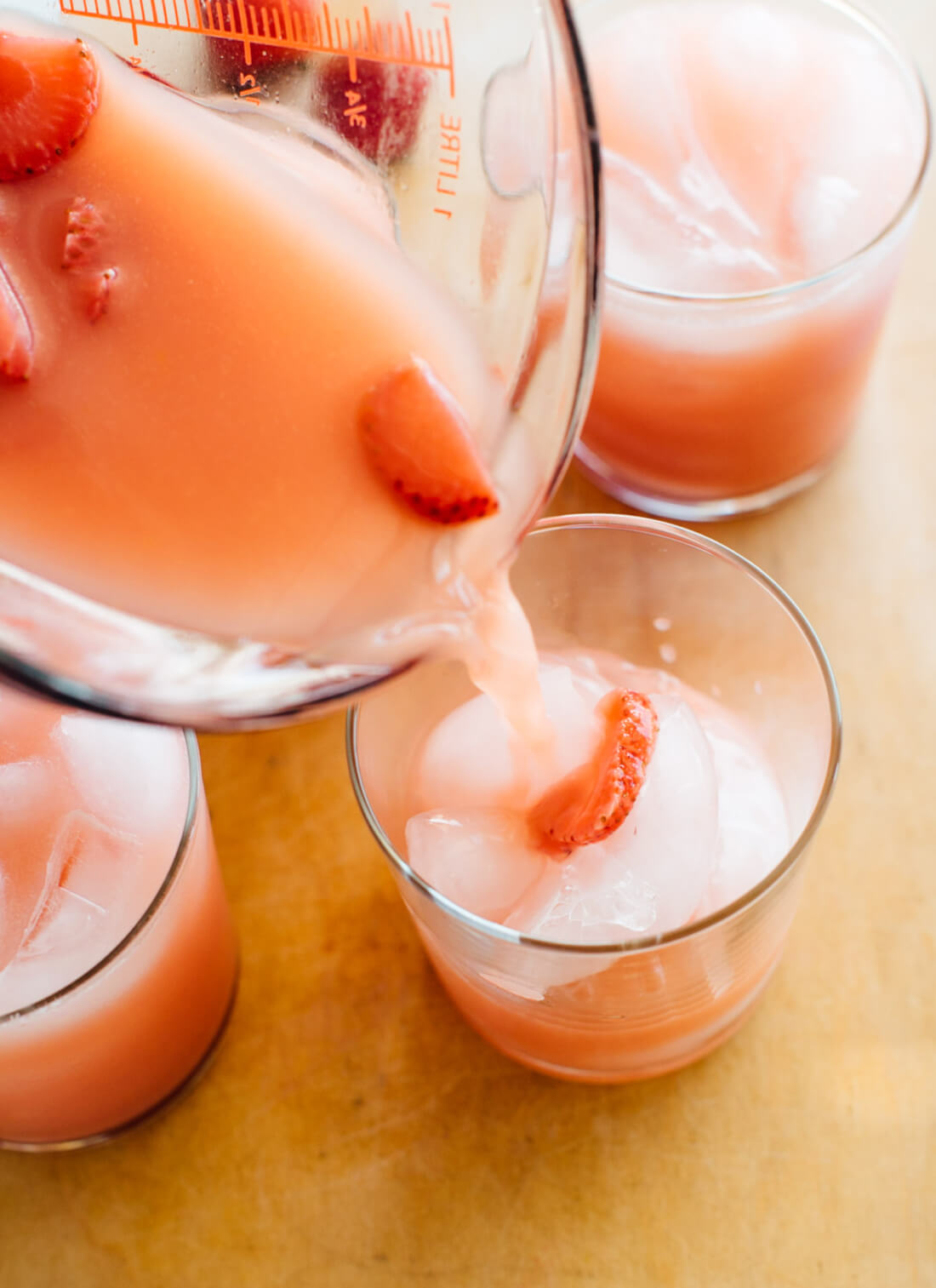 Pouring pink drink into glass