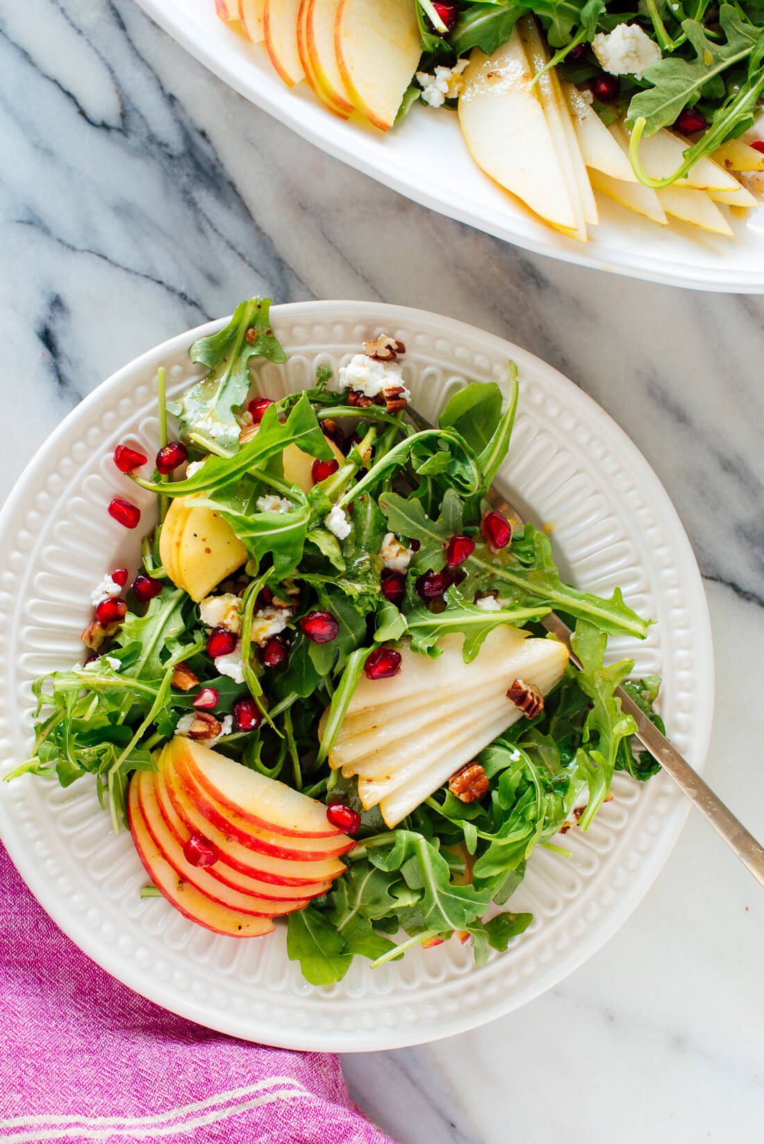 pomegranate pear arugula salad on plate