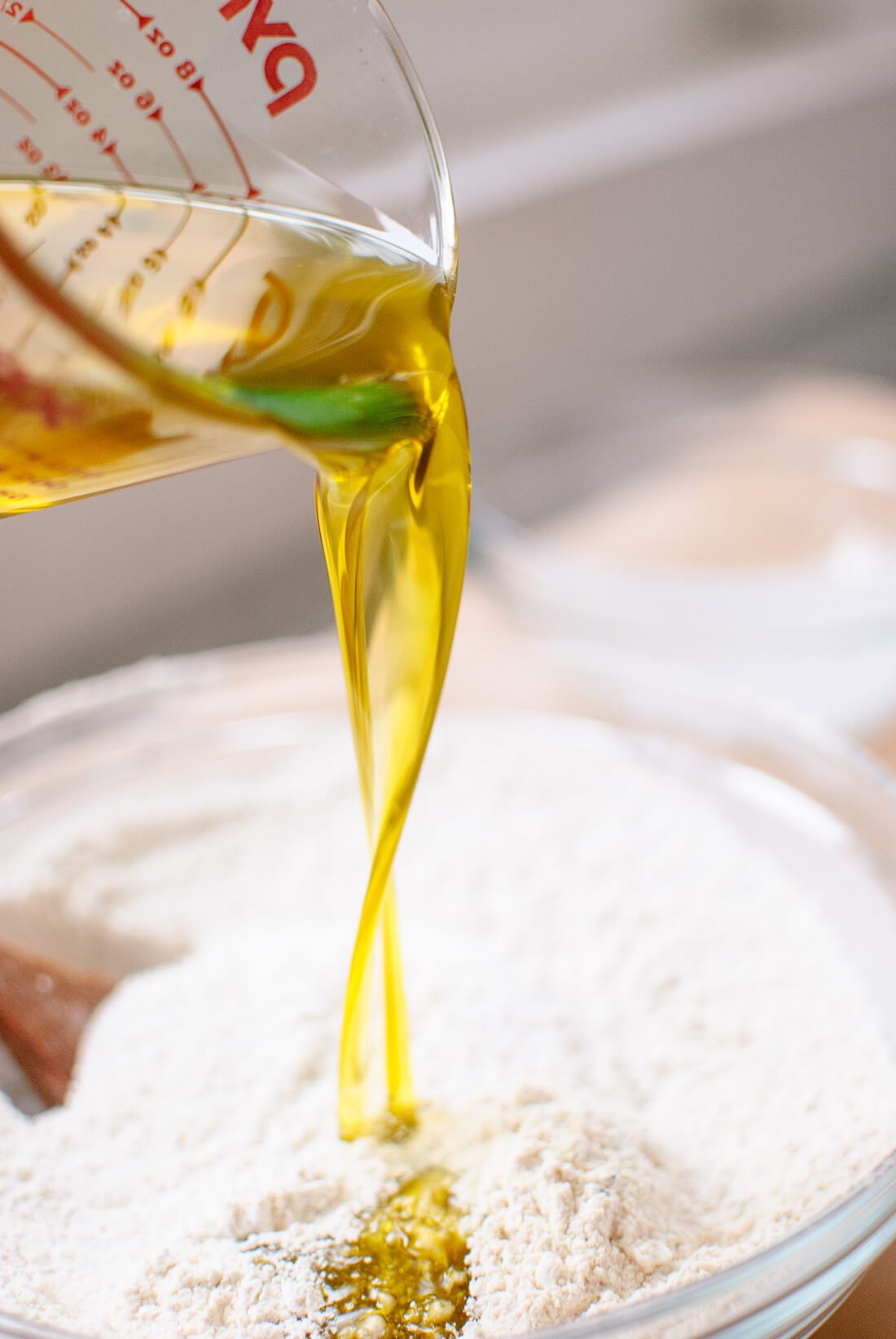 pouring olive oil into bowl