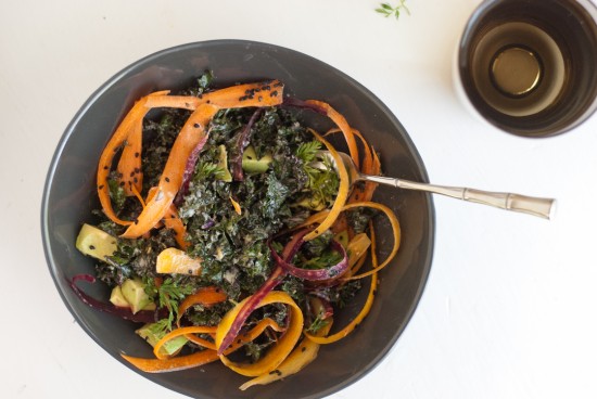 raw kale salad with tahini dressing, carrots and avocado