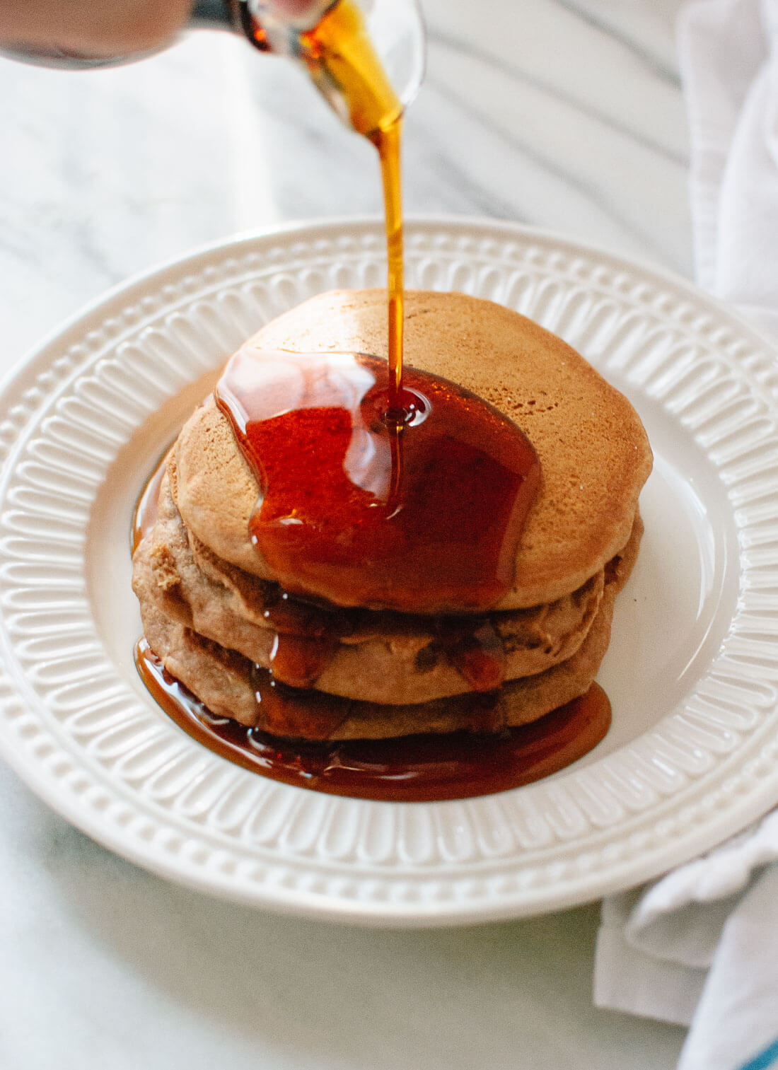 Super simple, healthy vegan pancakes. Who knew that eggless, whole grain pancakes could be so fluffy and delicious?! cookieandkate.com