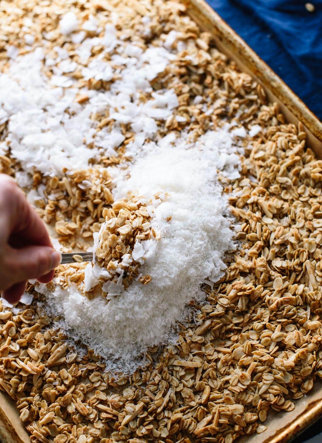 Stirring coconut into coconut granola - cookieandkate.com