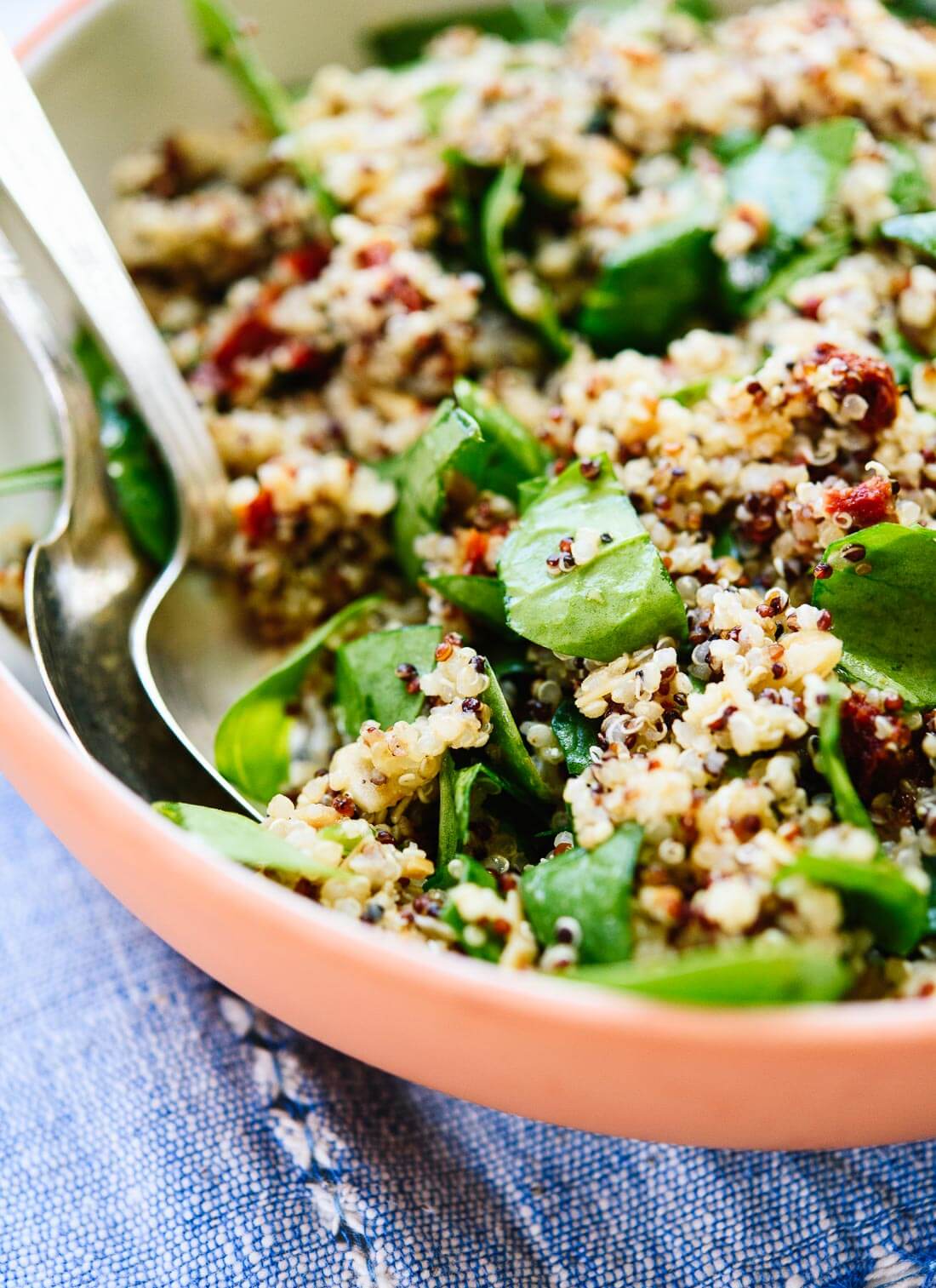 Simple quinoa salad with spinach, sun-dried tomatoes, toasted almonds and a zippy lemon dressing! cookieandkate.com