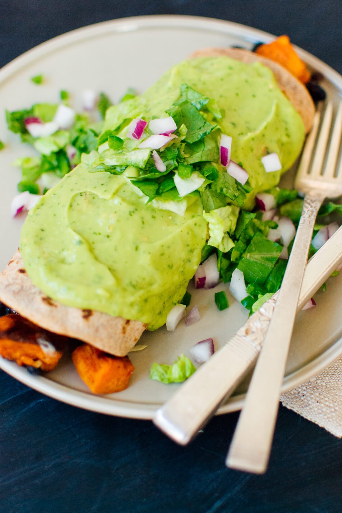 Sweet potato burrito smothered with avocado salsa verde