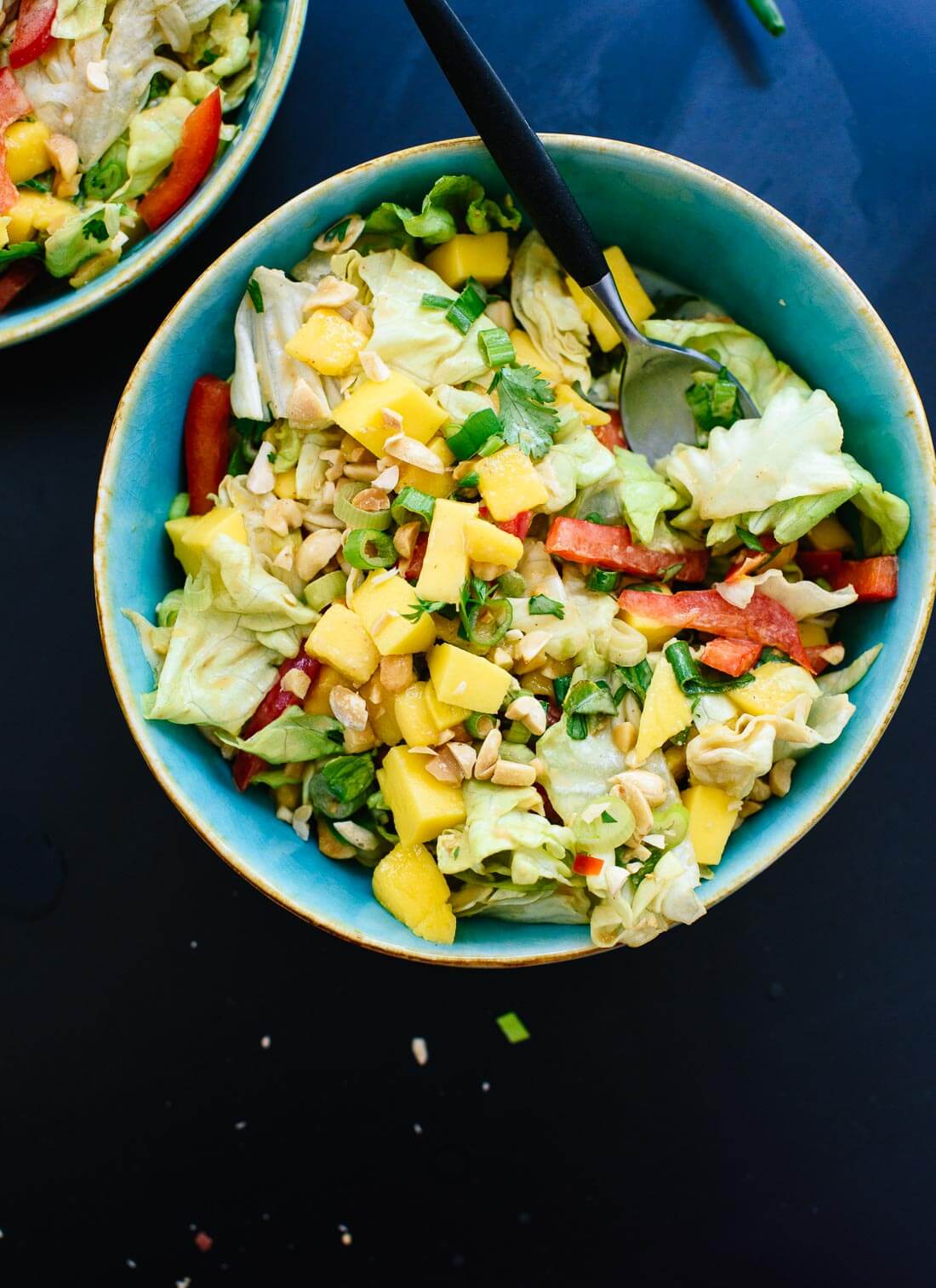 Fresh Thai green salad with sweet mango, bell pepper and a spicy peanut dressing! cookieandkate.com