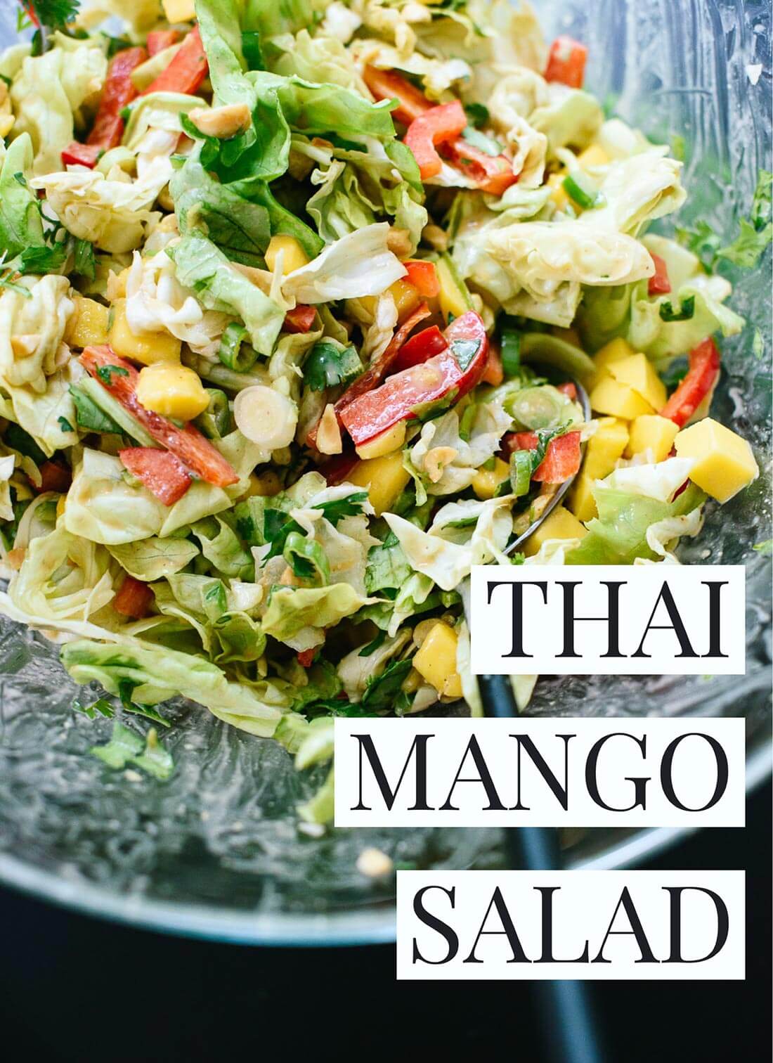 This fresh Thai-flavored salad features mango, bell pepper, greens and a delicious peanut dressing! cookieandkate.com