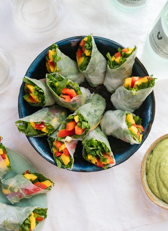 Tropical mango spring rolls with avocado cilantro sauce, a fresh appetizer to serve at your spring/summer parties! Gluten free and vegan. - cookieandkate.com