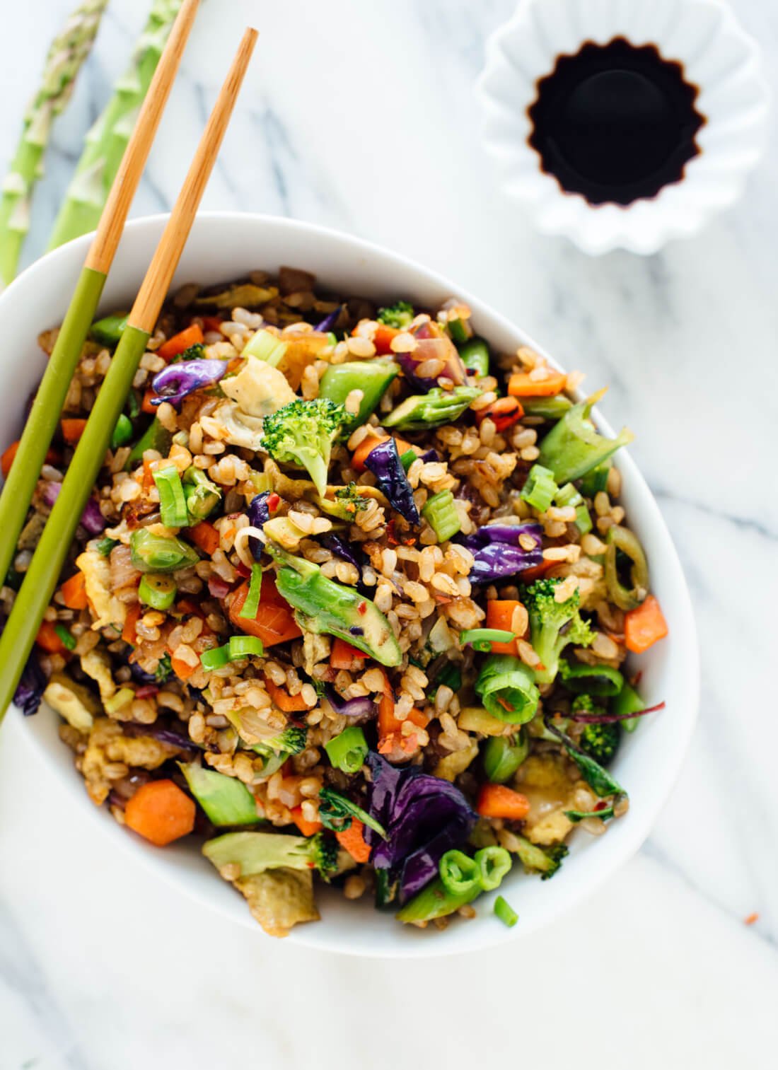 Vegetable fried rice recipe made with extra veggies and brown rice, for health and flavor bonus points! Get the recipe at cookieandkate.com